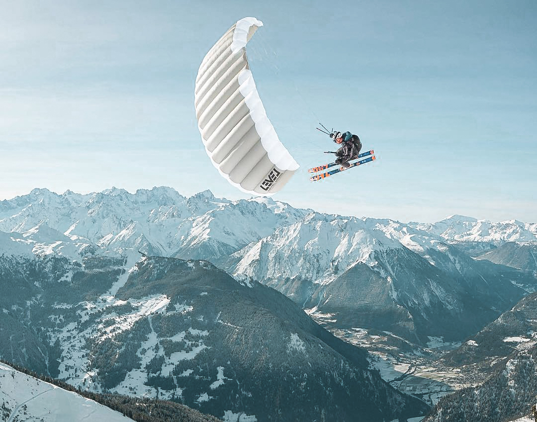 Extreme sports paragliding over a melting glacier