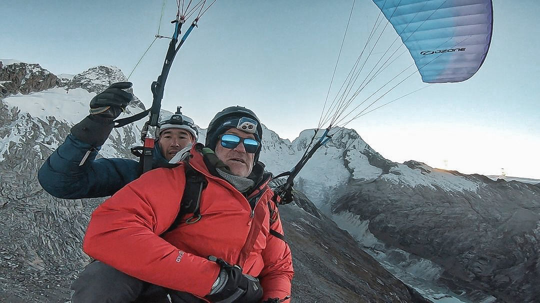 The Last Glaciers team paragliding over a melting glacier
